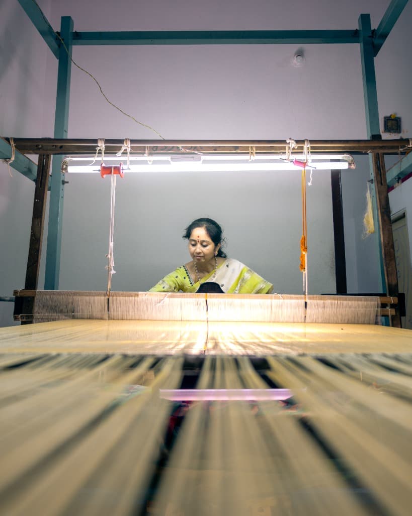 Weaver on a loom